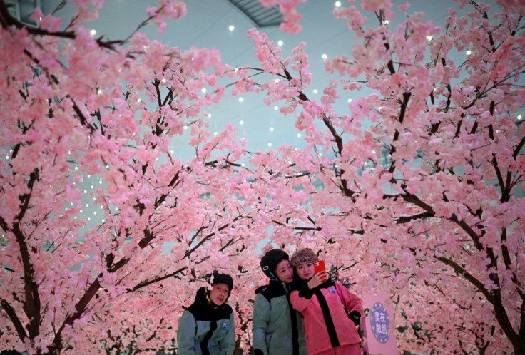 Visitors pose for pictures at the Sunac Snow Centre in China's southwestern Sichuan province