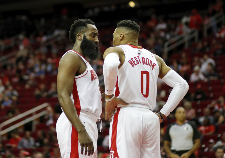 James Harden #13 of the Houston Rockets talks with Russell Westbrook #0