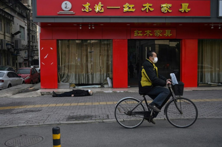 The lifeless body of a man lying on the street, not far from Wuhan hospital