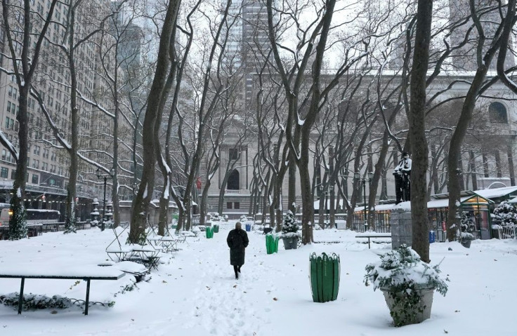 A person walks through Bryant Park on December 17, 2020 in New York, the morning after a powerful winter storm hit US northeastern states