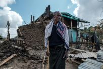 A man stands in front of his destroyed house in Ethiopia's Tigray region, which is due to receive an emergency aid package from the UN