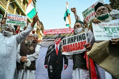 Muslims in Mumbai hold a placard of Chinese President Xi Jinping during a November 2020 protest against Beijing's treatment of the Uighur minority