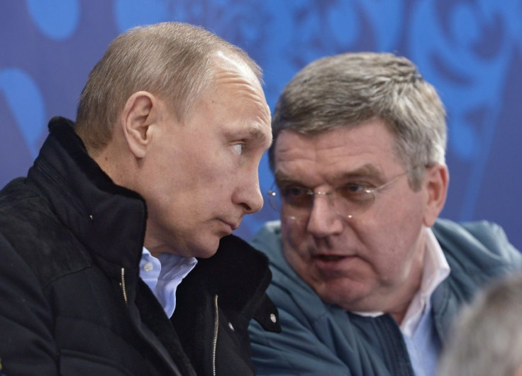 Russian President Vladimir Putin (L) speaks with IOC President Thomas Bach during the 2014 Winter Olympics in Sochi