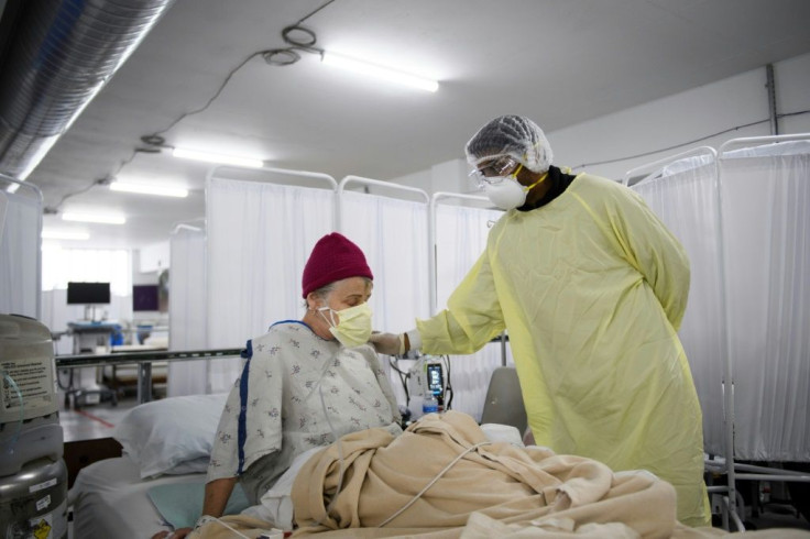 Dr. Bijay Sah examines a patient with Covid-19 at an indoor parking lot converted into a care unit in Reno, Nevada