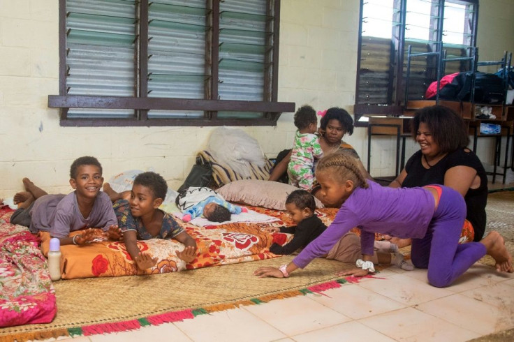 A Fijian family takes refuge in a temporary shelter during super cyclone Yasa in the capital city of Suva on December 17, 2020
