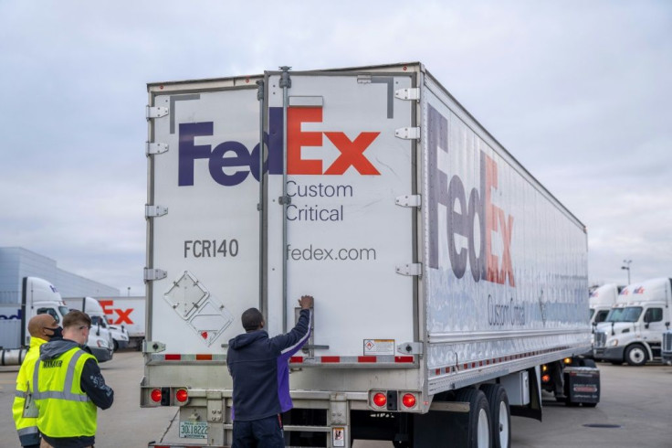 FedEx, shown here loading the Covid-19 vaccine, reported strong quarterly profits on higher e-commerce volumes