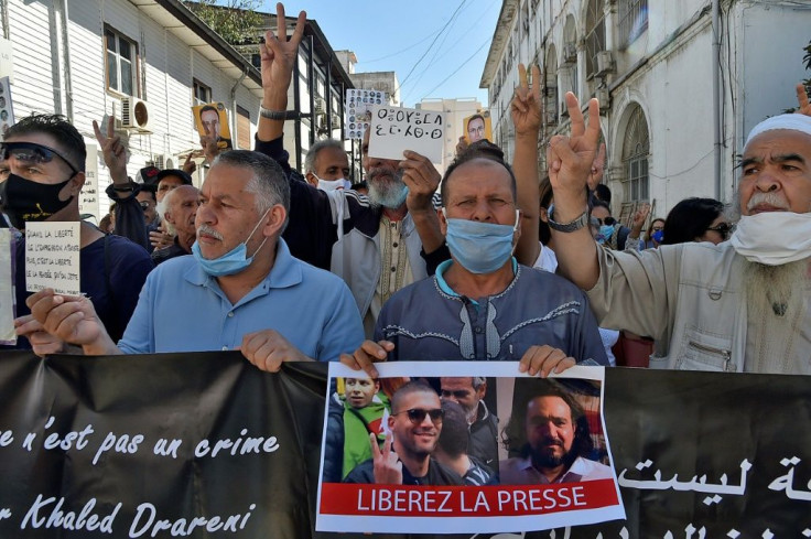 An Algerian demonstrator held up a sign reading in French 'Free the Press' at a protest in the capital Algiers calling for the release of jailed journalist Khaled Drareni in September