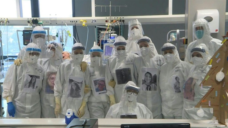 Italian healthcare workers display face on protective gear to reassure patients
