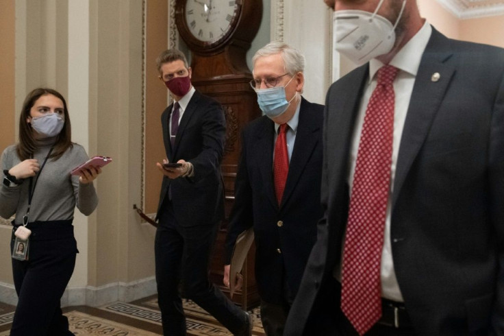 US Senate Majority Leader Mitch McConnell, Republican of Kentucky, walks to the Senate Floor at the US Capitol in Washington, DC on December 18, 2020