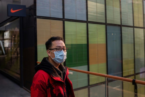 A man outside a Nike store in Beijing; strong China sales boosted results for the sports giant