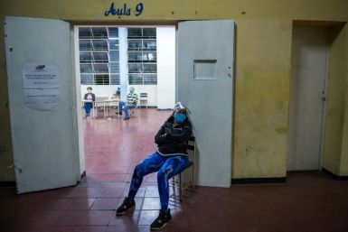 A poll worker waits for voters in Caracas on December 6, 2020 for parliamentary elections boycotted by the opposition and widely criticized internationally