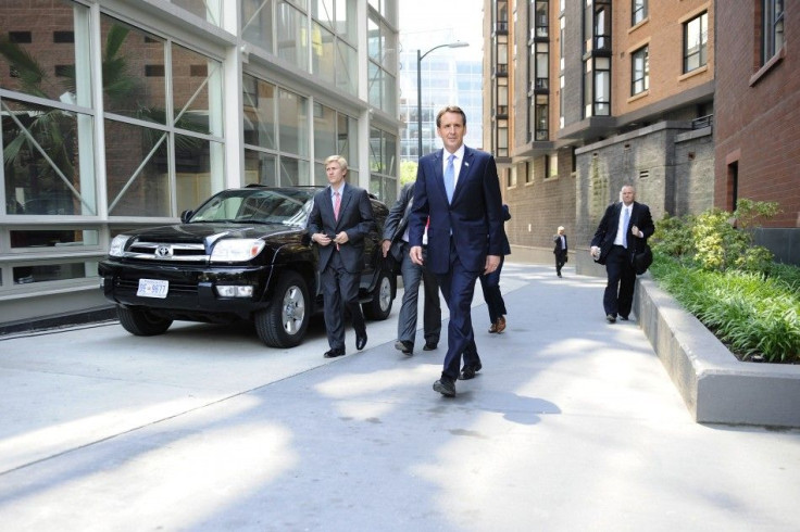 Pawlenty walks with staffers to hold a news conference after speaking at the Cato Institute in Washington