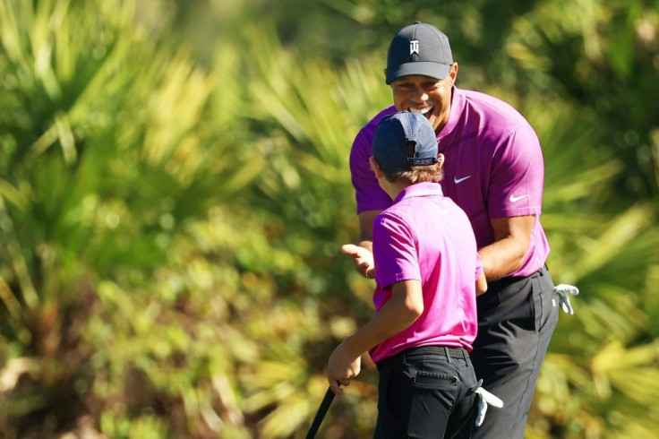 Tiger Woods congratulates son Charlie on his eagle in the first round of the PNC Challenge in Orlando, Florida