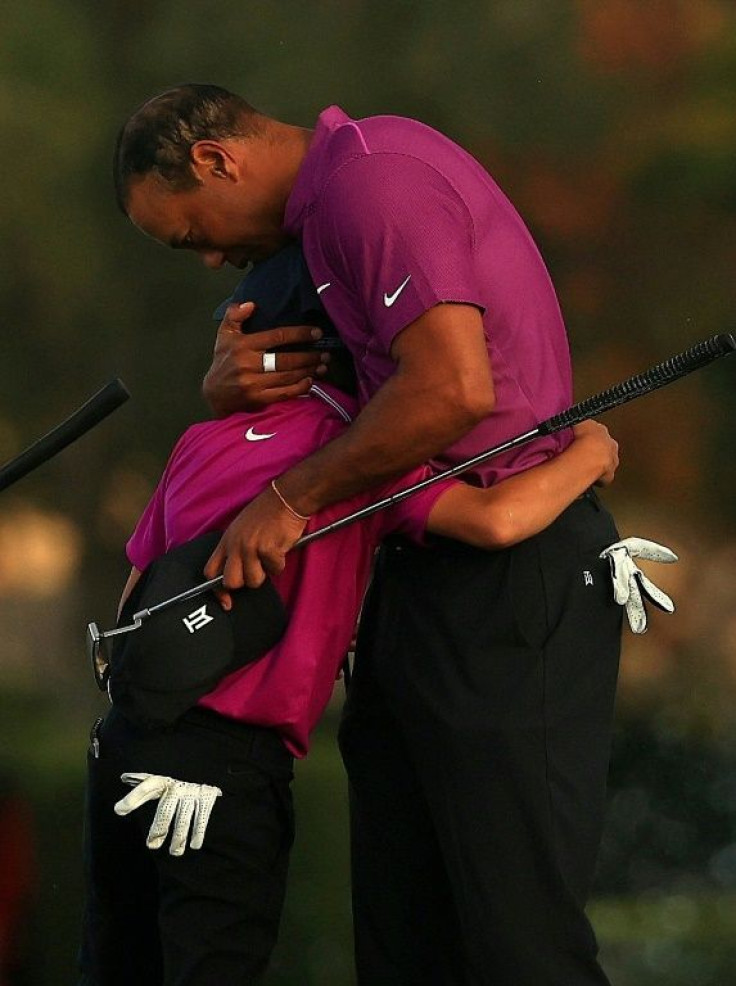 Tiger Woods and son Charlie share a hug after the first round of the PNC Championship family team tournament