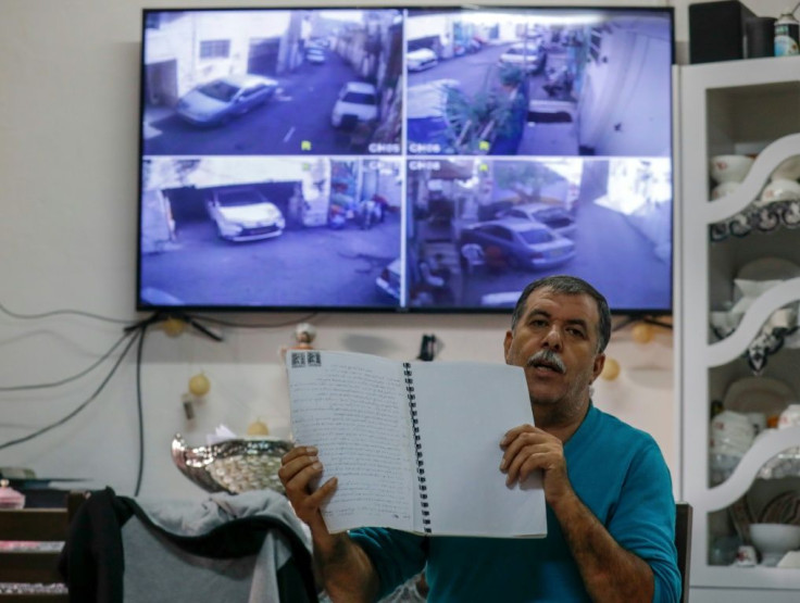 Palestinian Zuheir Rajabi has 10 surveillance cameras set up around his home, each displaying live footage