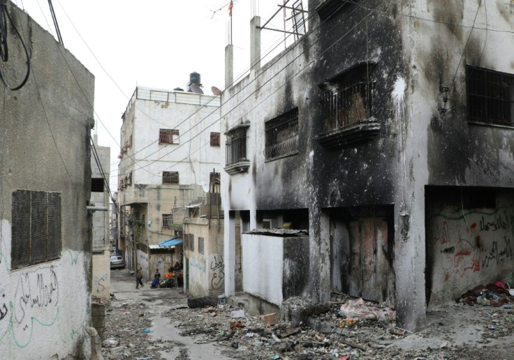 A building still shows the scorch marks from an arson attack during clashes in the camp