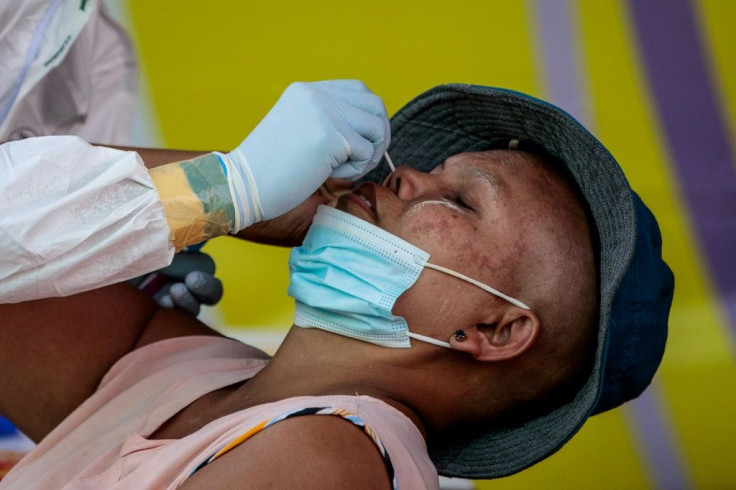 A worker is swabbed for a coronavirus test at Mahachai seafood market in Samut Sakhon after an outbreak among Mynmar migrant workers