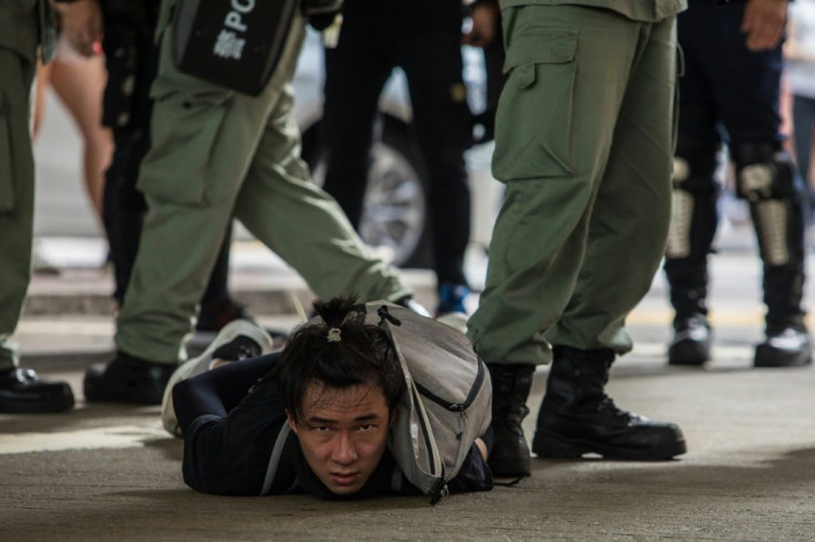 Hong Kong riot police detain a man as they clear protesters taking part in a July 1, 2020 rally against the new national security law imposed by Beijing