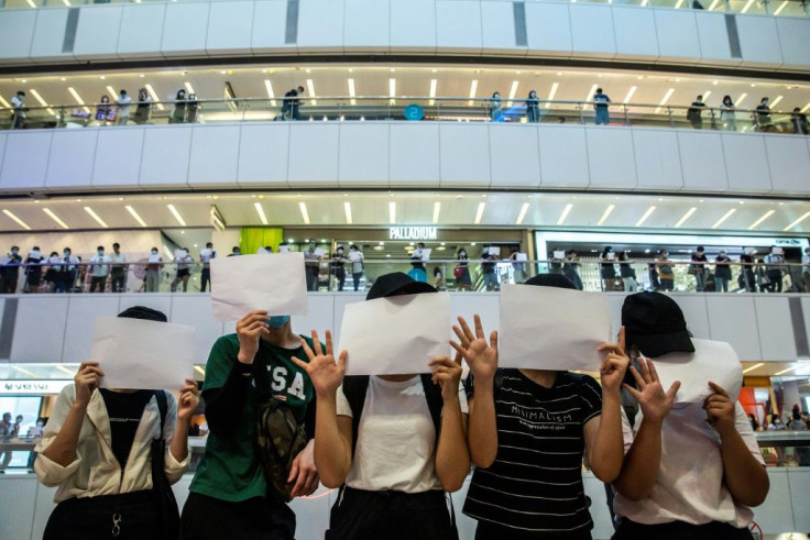 Hong Kong protesters hold up blank papers during a demonstration in response to the sweeping new national security law which outlaws a host of political views
