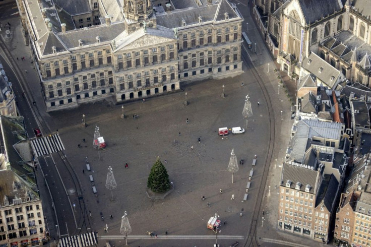 Amsterdam's Dam square is deserted but for a solitary Christmas tree as the country goes through a five-week lockdown