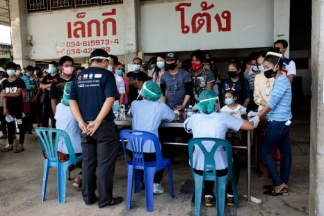 People waiting to get tested for coronavirus at a seafood market in Samut Sakhon