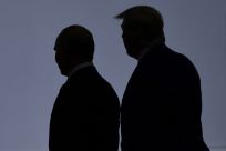 US President Donald Trump (R) walks in 2019 with President Vladimir Putin of Russia, which has been blamed for a massive cyberattack in the United States