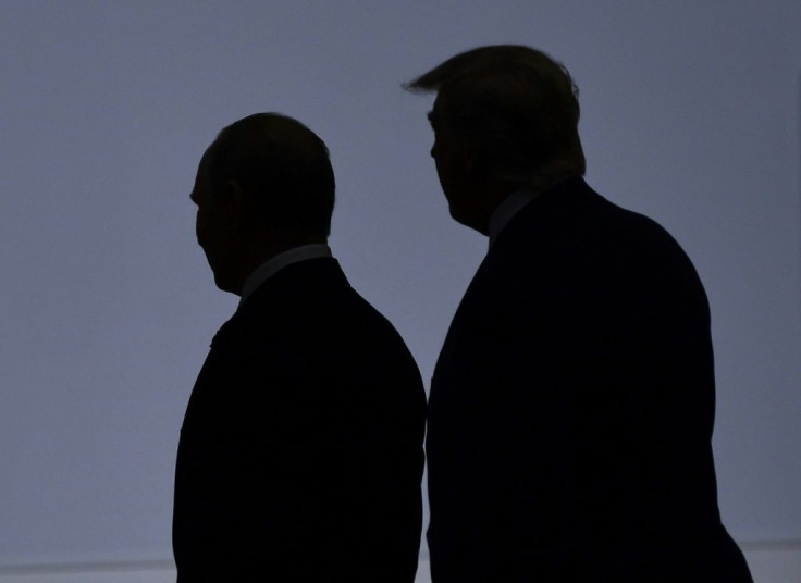 US President Donald Trump (R) walks in 2019 with President Vladimir Putin of Russia, which has been blamed for a massive cyberattack in the United States