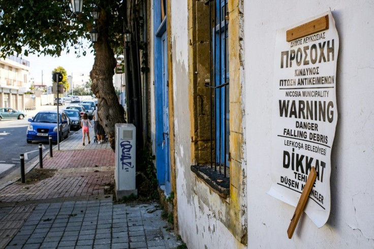 A warning sign in Greek, English and Turkish placed outside a derelict building at risk of collapse in Nicosia's old city