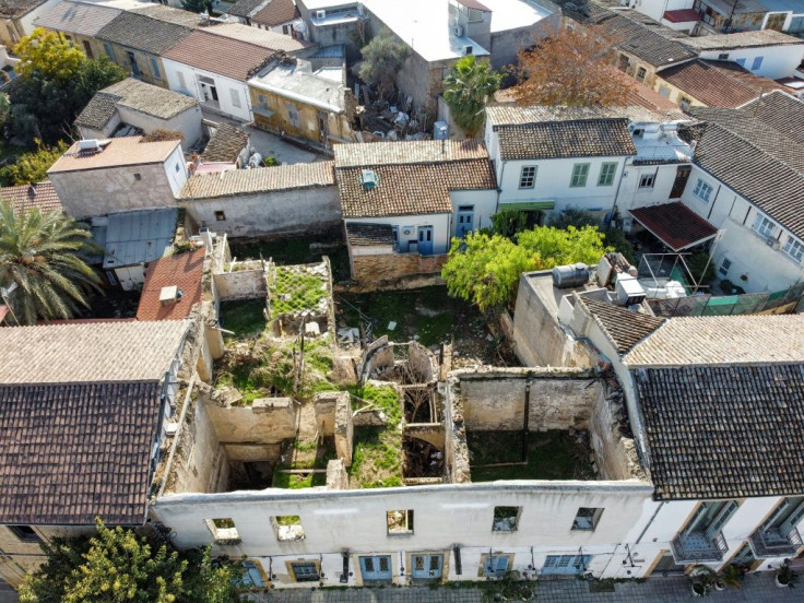 Derilect residences sometimes abut homes that remain in use in the Cypriot capital