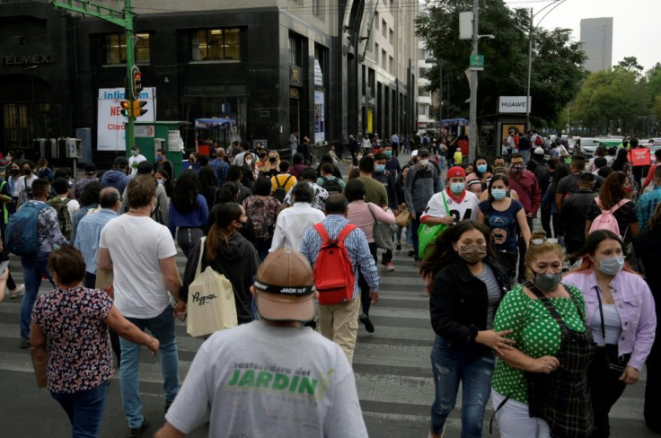 People walk in downtown Mexico City on December 16, 2020, amid the Covid-19 pandemic