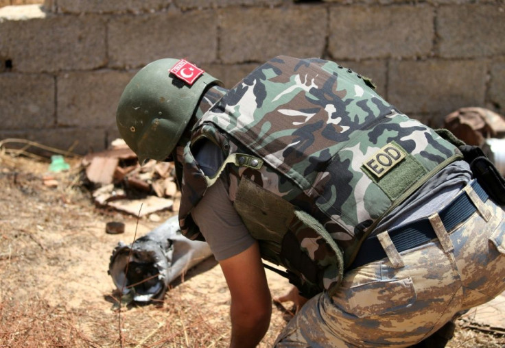 A Turkish deminer takes part in the clearance of unexploded ordnance south of the Libyan capital Tripoli on June 15