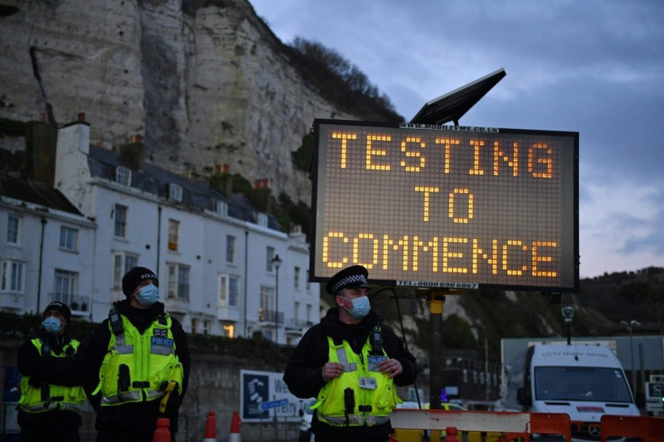 A sign in the English port of Dover says Covid-19 testing is set to begin on truck drivers who have been queueing to leave the UK