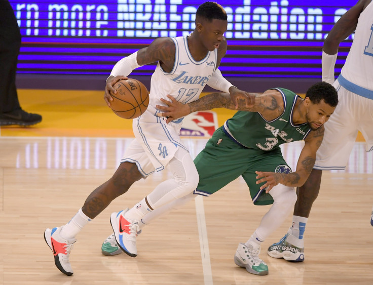 Trey Burke #3 of the Dallas Mavericks guards Dennis Schroder #17 of the Los Angeles Lakers 