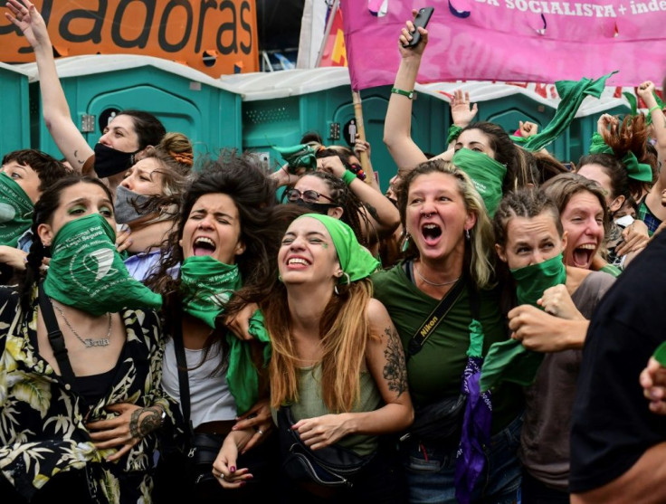 Demonstrators celebrate with green headscarves -- the symbol of abortion rights activists -- outside the Argentine Congress after legislators passed a bill to legalize abortion on December 11