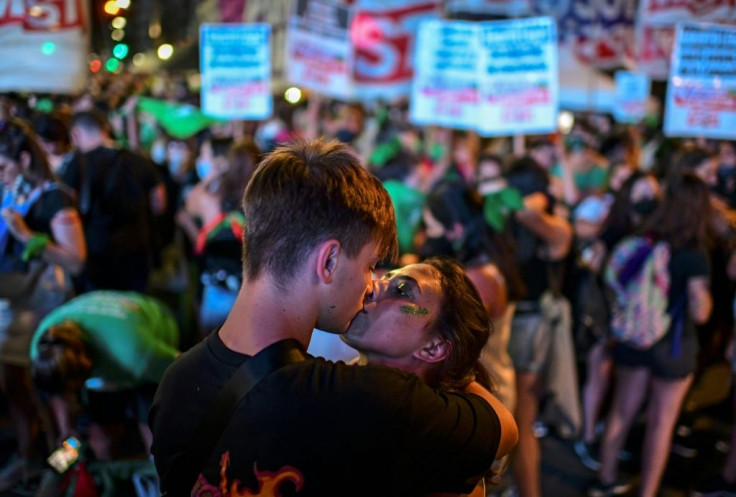 Abortion rights activists kiss outside the Argentine Congress on December 11