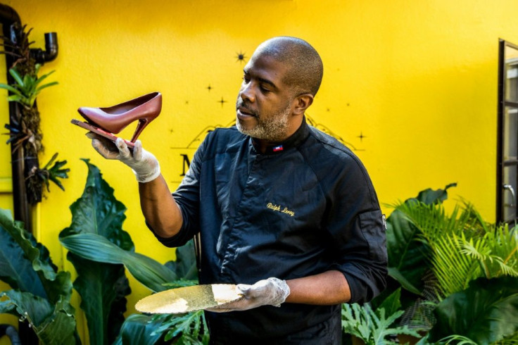 Master chocolatier Ralph Leroy, who owns the chocolate company Makaya in Petionville, Haiti, holds one of his creations: a high-heeled shoe made of chocolate