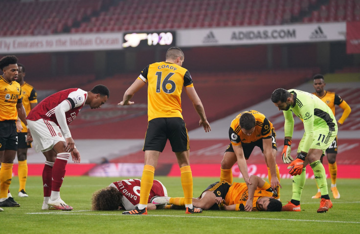  David Luiz of Arsenal and Raul Jimenez of Wolverhampton Wanderers