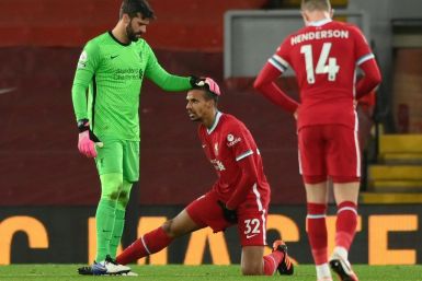 Taking the strain: Liverpool defender Joel Matip (centre) became the latest Premier League player to suffer a muscle injury in Sunday's 1-1 draw with West Brom