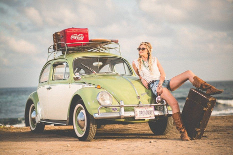 Woman leaning on beetle car