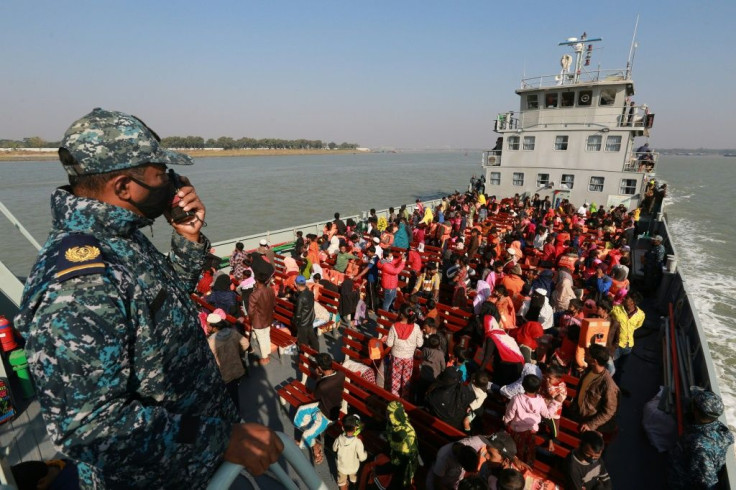 Rohingya refugees sit on a Bangladesh navy ship as they are relocated to the flood-prone island of Bhashan Char in the Bay of Bengal on Tuesday