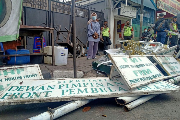 Police tore down signs at the headquarters of Indonesian hardline Islamic Defenders Front after banning the organisation
