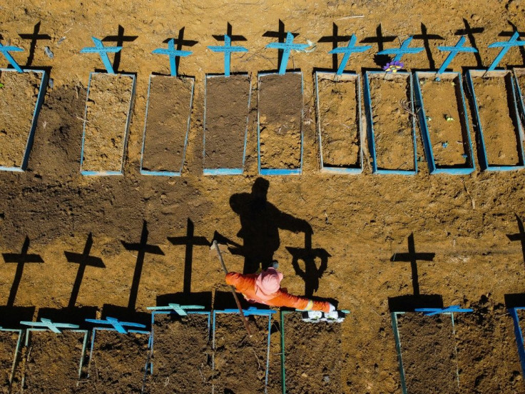 Aerial view showing a gravedigger standing at the Nossa Senhora Aparecida cemetery where COVID-19 victims are buried daily, in the neighbourhood of Taruma, in Manaus, Brazil, on June 2, 2020 during the novel coronavirus pandemic.