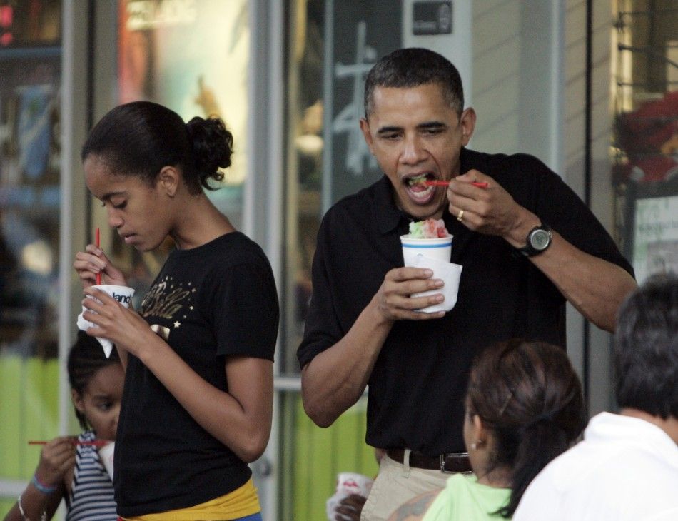 U.S. President Barack Obama and his daughter Malia eat quotshave icequot with family friends outside of Island Snow while they are on Christmas vacation in Kailua