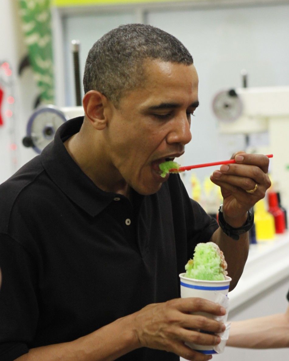 U.S. President Barack Obama eats quotshave icequot at Island Snow near where he is staying while he is on Christmas vacation in Kailua, Hawaii .
