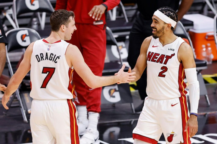 Miami's Goran Dragic celebrates with teammate Gabe Vincent after the Heat's 119-108 NBA victory over the Milwaukee Bucks
