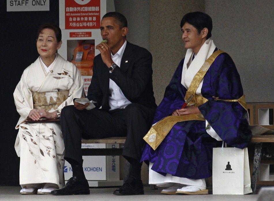 U.S. President Obama eats ice cream as he visits the Great Buddha statue in Kamakura, on the sidelines of the APEC summit