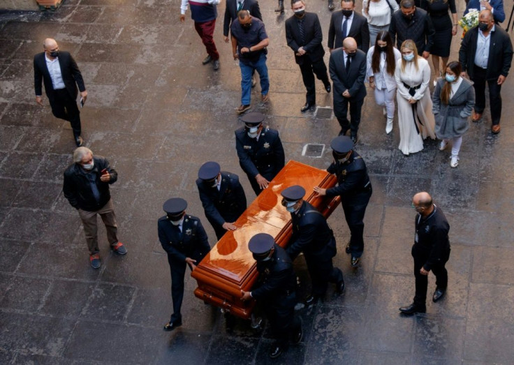 Relatives of the former governor of Mexico's Jalisco state, Aristoteles Sandoval, murdered in Puerto Vallarta in December, walk next to his coffin