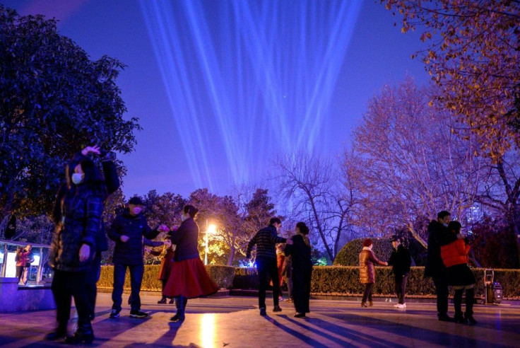 People dance on the banks of Yangtze River on New Year's Eve in Wuhan, Hubei province