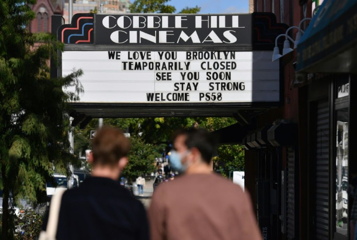 People walk past the Cobble Hill Cinemas movie theater on October 8, 2020 in New York City, which has been closed for months due to the coronavirus pandemic