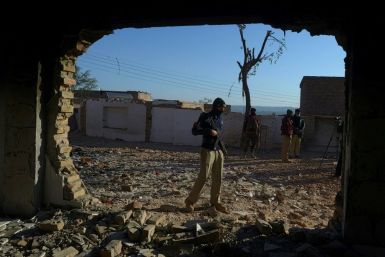 Police stands guard at the destroyed Hindu temple in Karak district